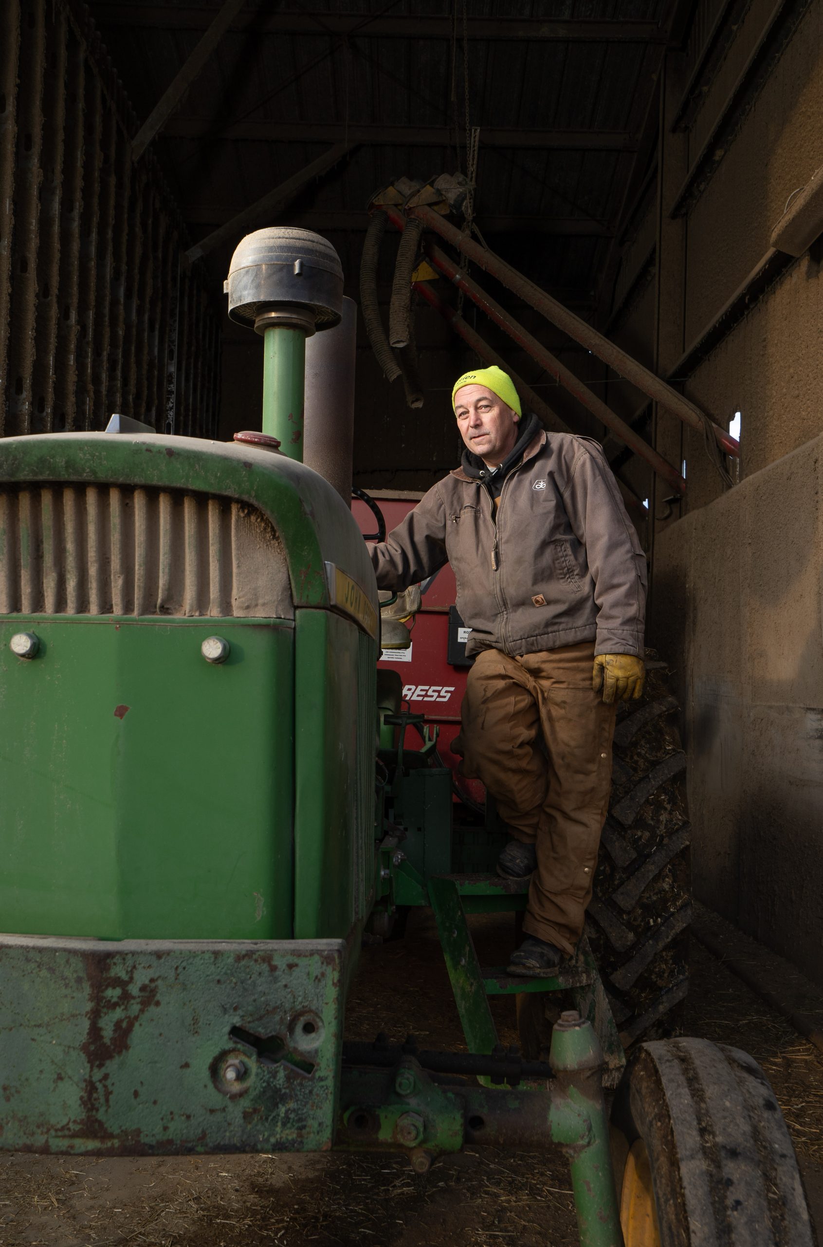 Aaron Haines on his tractor after feeding the cows